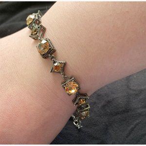 Delicate bracelet with amber colored stones.